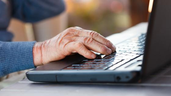 Closeup of an old man using the modern technology.