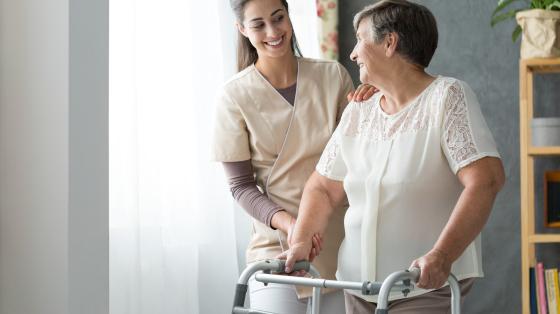 nurse assisting elderly woman