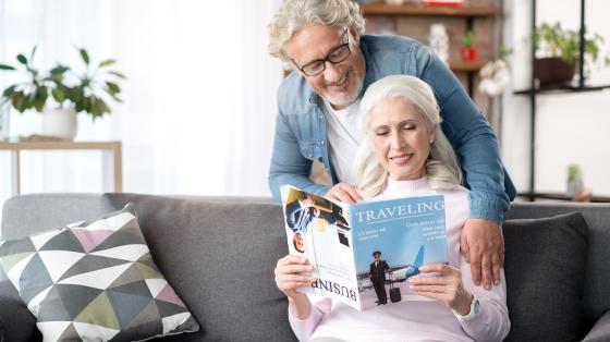 Joyful mature husband and wife entertaining at home together