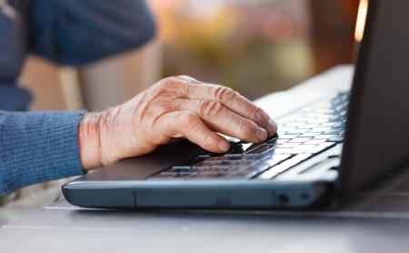 Closeup of an old man using the modern technology.